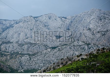Beautiful mountain ranges with high peaks natural elevation of earth surface on blue sky background with green nature
