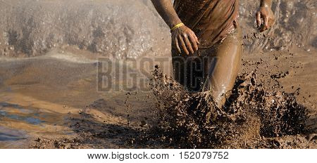 Mud race runners man running in mud