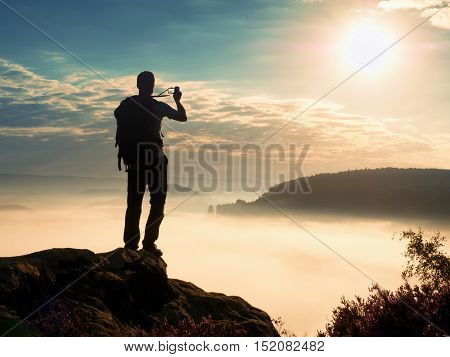 Amateur Photographer Takes Impressive Photos With Phone. Hiker With Backpack