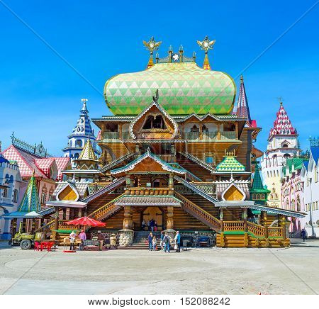 MOSCOW RUSSIA - MAY 10 2015: The facade of carved and painted wooden Tsar's Palace in Izmailovsky Kremlin with patterned dome various towers figured porches and double-headed eagles on the weathervanes on May 10 in Moscow.