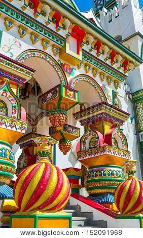 The splendid porch of the traditional Russian style church in Izmailovsky Kremlin with complex decors figured pillars covered with floral patterns Moscow Russia.