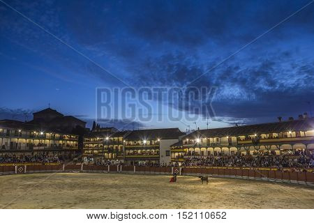 Chinchon Spain - October 15 2016: Plaza square Mayor of Chinchon adapted as a bullring Detail of balconies illuminated dressed with the Spanish flag beautiful sunset at Chinchon Spain