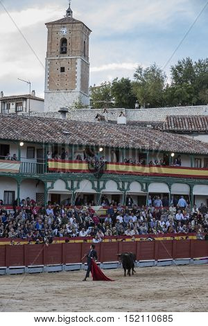 Chinchon Spain - October 15 2016: Traditional bullfighting stamp in the main square of chinchon during the festival charity Chinchon Madrid province Spain