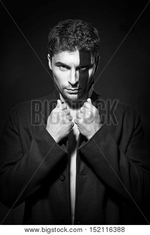 Portrait of a handsome young man in body painting