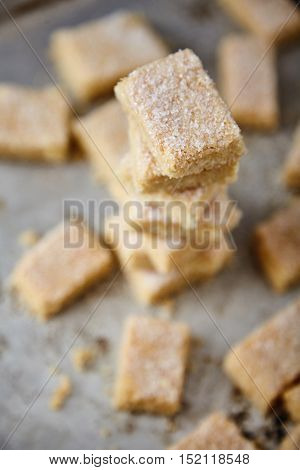 Delicious homemade sugar cookies made from semolina, butter, flour and sugar. Crumbly, delicate texture, the sugar crust on top. A little sweetness to the tea on gray background. Selective focus