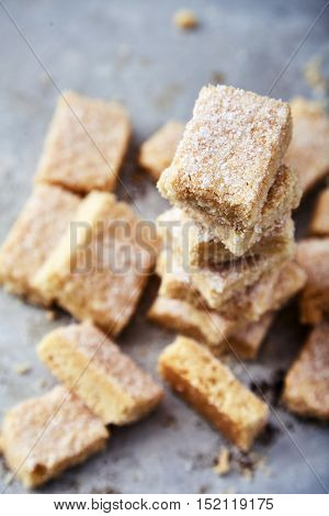 Delicious homemade sugar cookies made from semolina, butter, flour and sugar. Crumbly, delicate texture, the sugar crust on top. A little sweetness to the tea on gray background. Selective focus