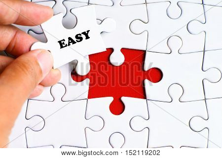 Missing puzzle with a hand hold a piece of 