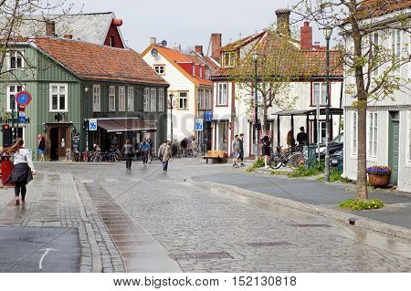 Trondheim, Norway - May 29, 2016: People walking the street Ovre Bakklandet in the Trondheim Old town.