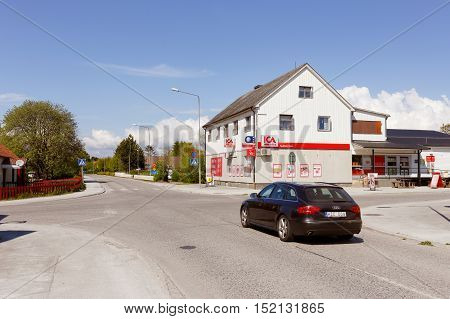 Havdhem Sweden - May 14 2016: A car driving on the concrete road in front of the Ica grocery store through the village in the direction of Visby on county road 142 in the Swedish province of Gotland.