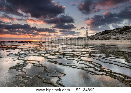Sunset at Trafalgar beach nearby lighthouse where the great battle of Trafalgar took place. Costa de la Luz Cadiz Spain