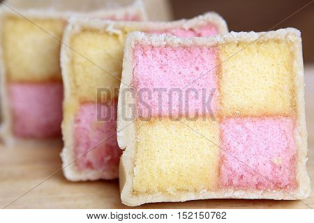 Freshly Cut Battenberg Cake Slices With Pink And Yellow Sponge Covered In Marzipan