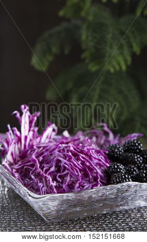 salad of red cabbage and blackberry on a dark background