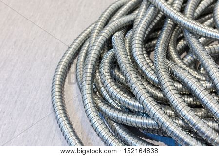 Flexible metal pipe on a background .