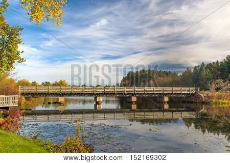 Bridge Featuring Autumn Vibrant Colors On Apple River