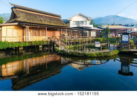 Oshino, Japan - September 2, 2016:Oshino Hakkai Fuji Five Lakes. Japan countryside landscape of traditional thatch roof farmhouses and pond with crystal clear blue water