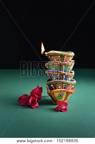Diwali festive background and object. Many colorful handmade Diyas stacked on each other.