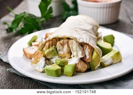 Wrap sandwich with chicken and avocado close up view