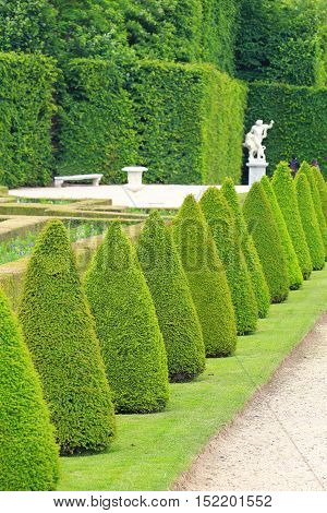 Statue on a path of Versailles garden Paris France