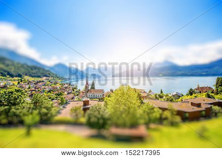 Landscape view on Weggis village on Lucerne lake with beautiful mountains on the background in Switzerland. Tilt-shift image technic