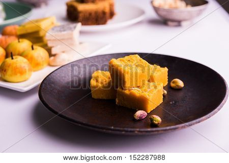 almond, pista, mango and orange flavoured pedha and burfi Indian sweet dish made from milk , dry fruits and fruits, diwali food