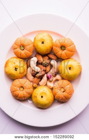 almond, pista, mango and orange flavoured pedha and burfi Indian sweet dish made from milk , dry fruits and fruits, diwali food