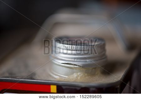 CLose-up detail of the cap of an old metal paint thinner can. Construction and DIY home renovation concept.
