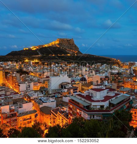 Aerial night view of Alicante Costa Blanca Spain. Old city center with harbor illumination. Santa Barbara Castle located on Mount Benacantil
