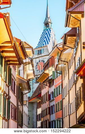Beautiful colorful buildings with clock tower in Zug village near Zurich city in Switzerland. Typical historical swiss architecture