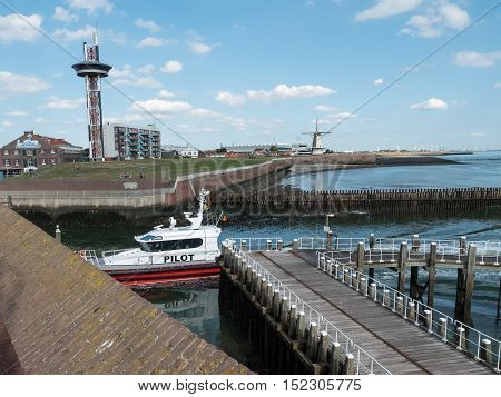 VLISSINGEN, NETHERLANDS - 12 SEPT. 2016: Pilot boat entering the harbor of Vlissingen in the province of Zeeland, Netherlands. Pilots boats assist large cargo ships on the North Sea to enter the port.