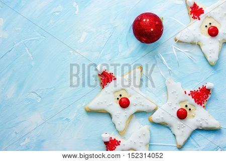 Christmas festive homemade decorated cookies on blue background top view