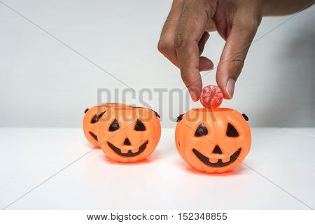 Put red candy into Jack-O-Lantern pumpkin for Halloween