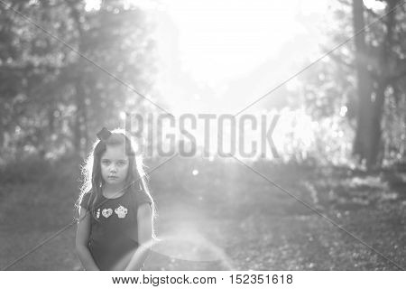 artistic low key black and white portrait of a sad little girl