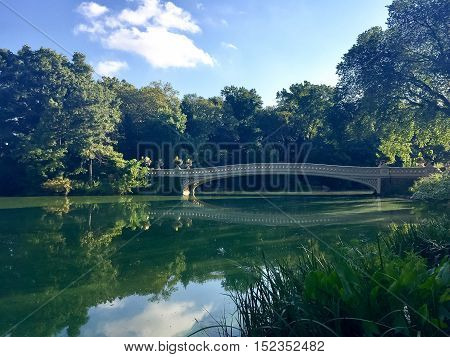 Bow Bridge reflects on the lake in the morning at Central Park, Manhattan, New York