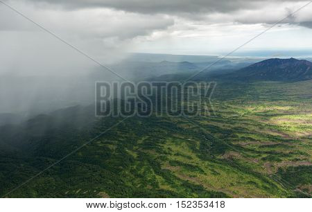 Rain in the Kronotsky Nature Reserve on Kamchatka Peninsula. View from helicopter.