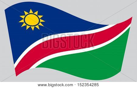 Namibian national official flag. African patriotic symbol banner element background. Correct colors. Flag of Namibia waving on gray background vector