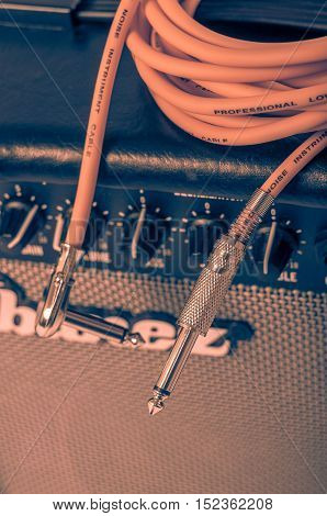 Close-up of guitar amplifier with jack cable.