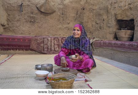 Nizwa Oman October 13th 2016: omani lady preparing sandlewood paste