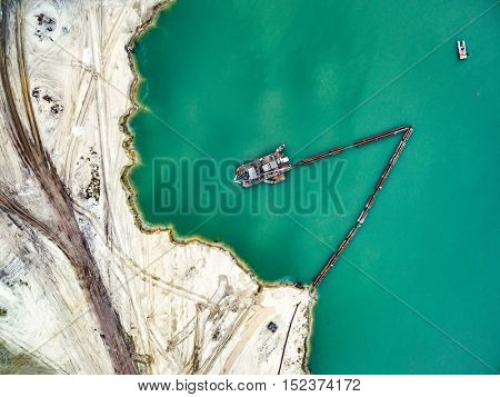Aerial view - blue water in pond, sandy career