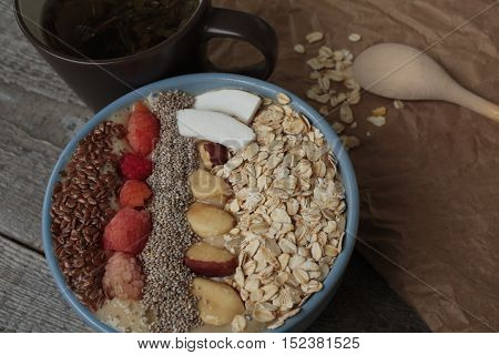 Breakfast berry smoothie bowl topped with raspberries, Chia, flax seeds, coconut, Brazil nut