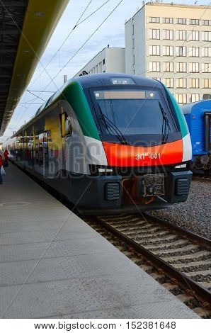 MINSK BELARUS - OCTOBER 1 2016: Unidentified people are waiting to board in electric train of business class EPM-001 of company Stadler (line Minsk-Gomel) on platform of railway station Minsk