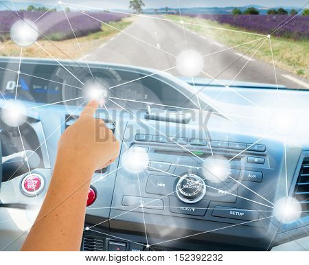 Self-driving car concept - someones hand programming modern car