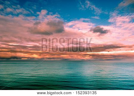 Multicolored surreal sunset view of a sea horizon. Beautiful landscape photography. Background tecture for travel and adventure.