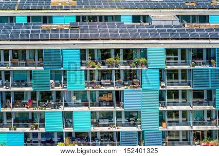 Zurich, Switzerland - June 28, 2016: Modern residential building's facade with solar panels in Oerlikon district in Zurich in Switzerland