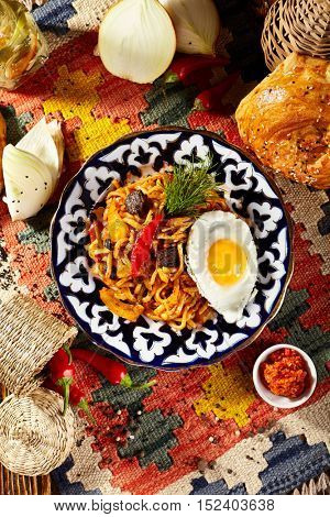 Asian Style Noodles with Meat and Laghman Sauce. Garnished with Fried Egg