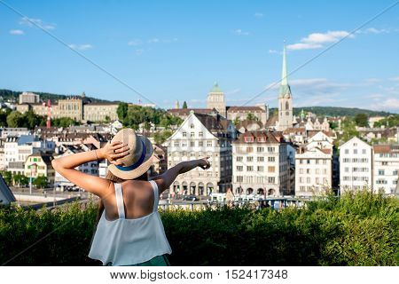 Young female tourist enjoying the beautiful old townscape view in Zurich city. Having a happy vacation in Switzerland
