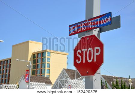 VIRGINIA BEACH, USA - MAY 4, 2012: Beach Street USA Sign and Stop Sign in Virginia Beach Oceanfront in Virginia Beach, Virginia, USA.