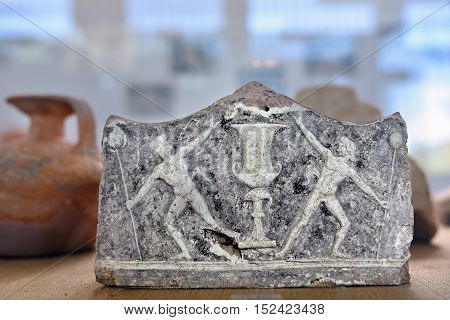 Nemea Greece - Sept 23 2016: An antique ceramic depicting athletes - winners of sports games in the museum of ancient Nemea one from a lot of archaeological sites in Greece