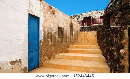 Narrow street with old houses in the fishers village Puertito on the Canary Island Lobos Fuerteventura Spain.
