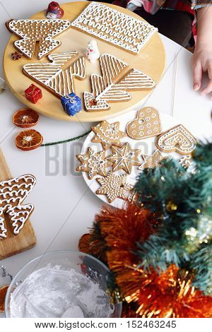 Decorated christmas gingerbread cookies and edcorations on the table.