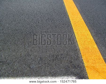 Background asphalt. On asphalt white and yellow stripes